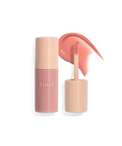 A pink lip gloss tube labeled "hince" with an open applicator and a swatch of the gloss beside it.